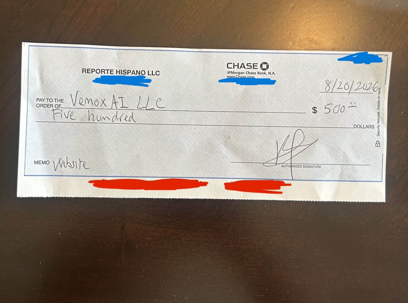 Reporte Hispano payment check for $500 with private details obscured